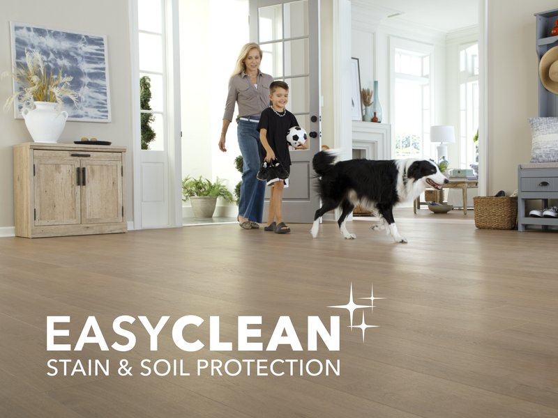 Family running with a dog on a durable Mohawk SolidTech R Floor