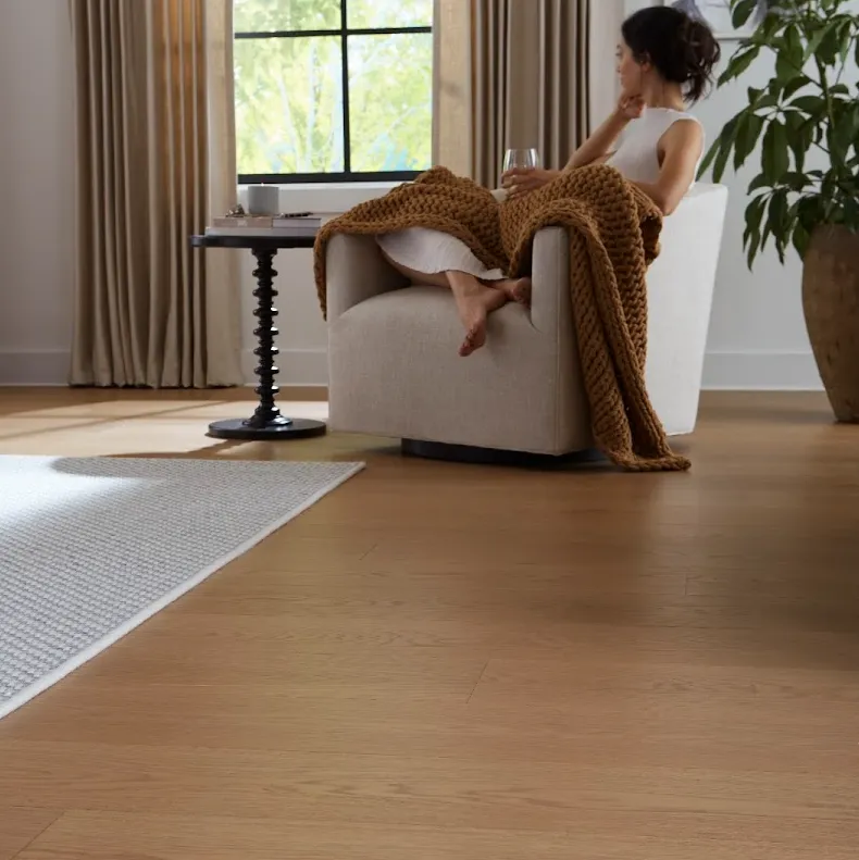 Woman sitting in stylish home with BelleLuxe Flooring