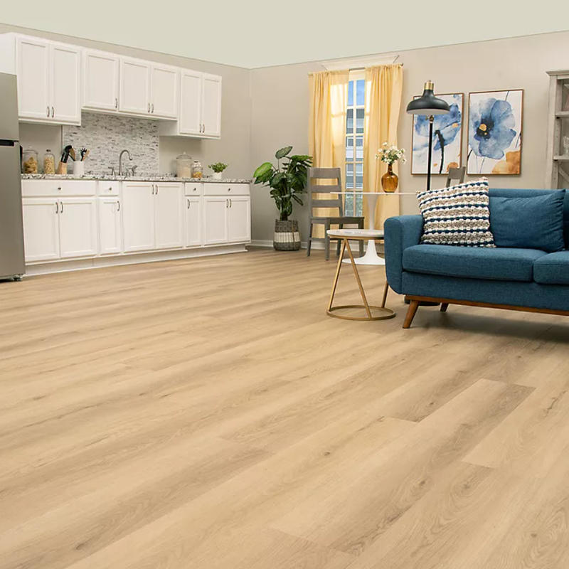 Studio living space with light UltimateFlex vinyl flooring and a blue sofa